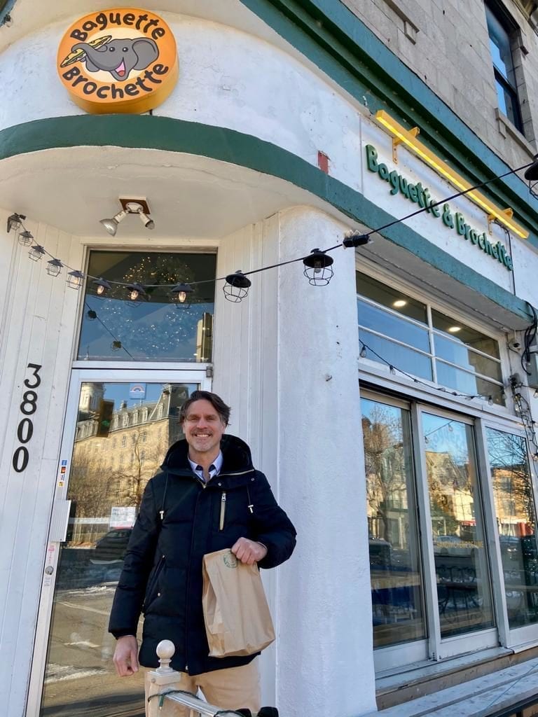 Our real estate broker Remy Babin in front of Baguette & Brochette, a restaurant on the Plateau Mont-Royal,